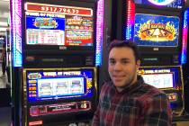 Ryan C. of Columbus, Ohio, celebrates his 25-cent Wheel of Fortune Triple Red Hot 7 machine vic ...
