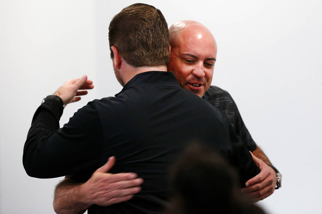 UNLV football head coach Tony Sanchez, face to camera, receives a hug from Rick Strasser, chapl ...
