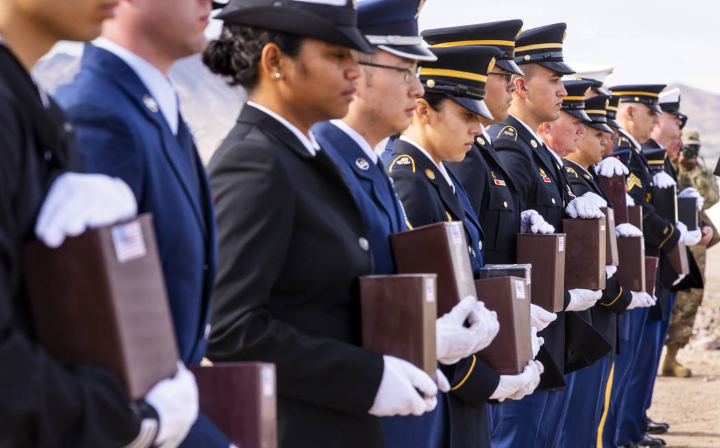 Military Honor Guard members with urns arrive at their burial plots during the third Missing in ...