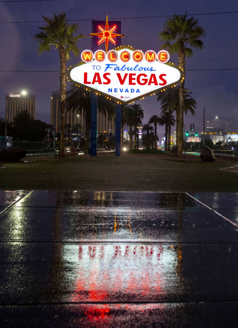 Rain falls at the Welcome to Fabulous Las Vegas sign at the Strip in Las Vegas on Wednesday mor ...