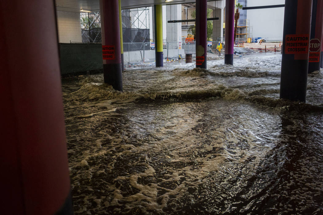 Heavy rain waters cause flooding at the LINQ parking garage on the Strip in Las Vegas on Wednes ...