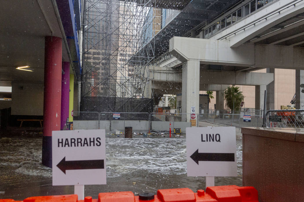 Heavy rain waters cause flooding at the LINQ parking garage on the Strip in Las Vegas on Wednes ...