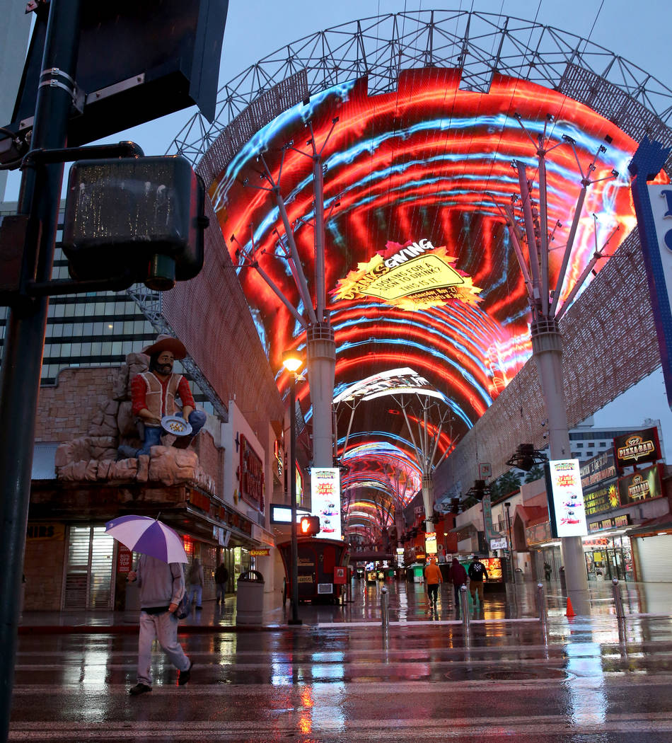 People walk through the Fremont Street Experience in downtown Las Vegas, Wednesday, Nov. 20, 20 ...