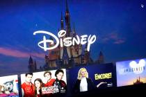 In a Wednesday, Nov. 13, 2019, file photo, a Disney logo forms part of a menu for the Disney Pl ...