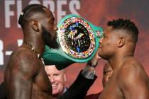 Deontay Wilder, left, and Luis Ortiz, pose during a weigh-in at the MGM Grand Garden Arena in L ...