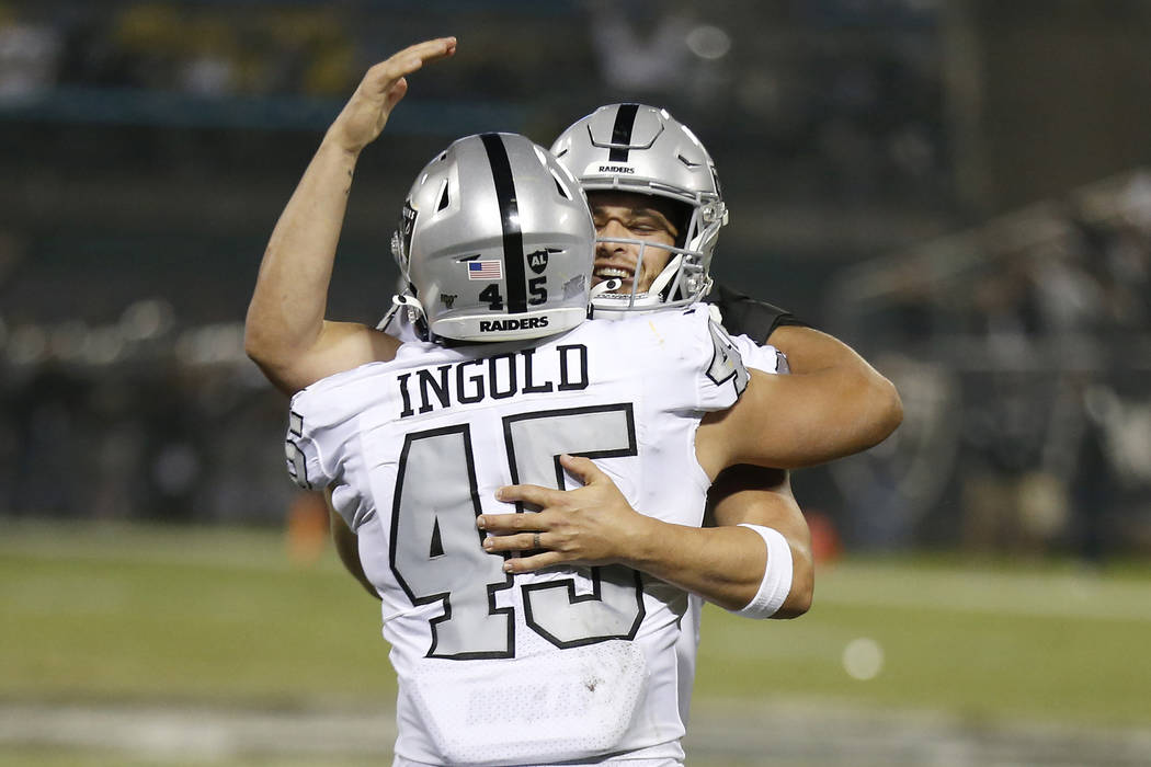 Oakland Raiders running back Alec Ingold (45) celebrates with quarterback Derek Carr after they ...