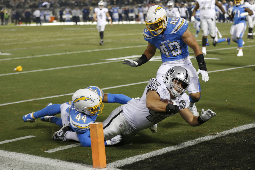 Oakland Raiders running back Alec Ingold (45) dives for the end zone to score past Los Angeles ...