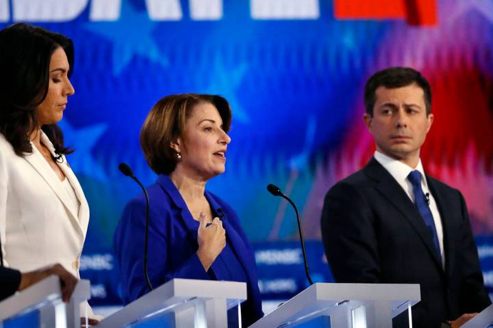 Democratic presidential candidate Sen. Amy Klobuchar, D-Minn., center speaks as Democratic pres ...