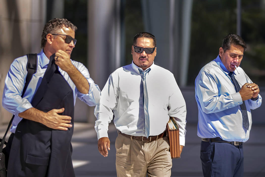 Counselor Mark Fleming, left, walks out with defendant Albert Lopez past defendant Bradley Camp ...