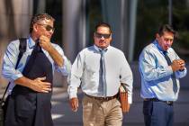 Lawyer Mark Fleming, left, walks with defendant Albert Lopez, past defendant Bradley Campos, ou ...