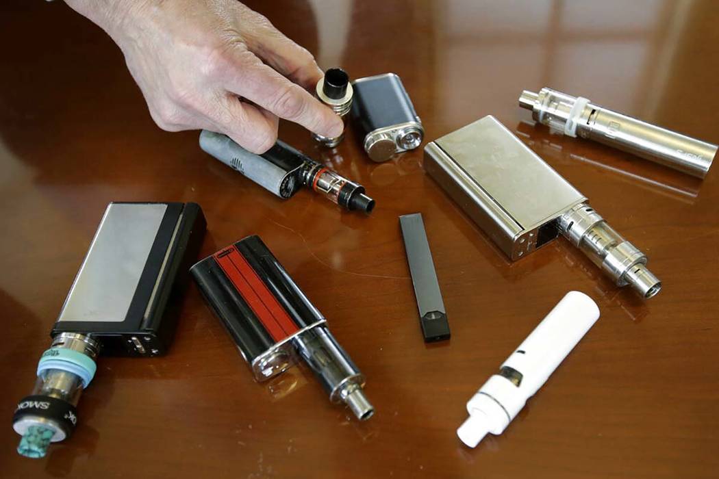 In a April 10, 2018, file photo, a high school principal displays vaping devices that were conf ...