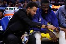 Golden State Warriors' Stephen Curry, left, points to the fingers of teammate Draymond Green du ...