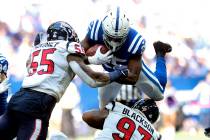 Indianapolis Colts' Marlon Mack (25) is tackled by Houston Texans' Benardrick McKinney (55) and ...