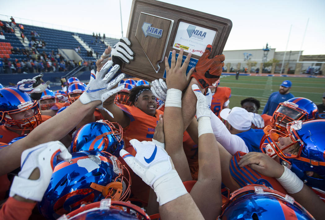 Bishop Gorman celebrates its 42-28 victory over Liberty High School following the NIAA 4A Deser ...