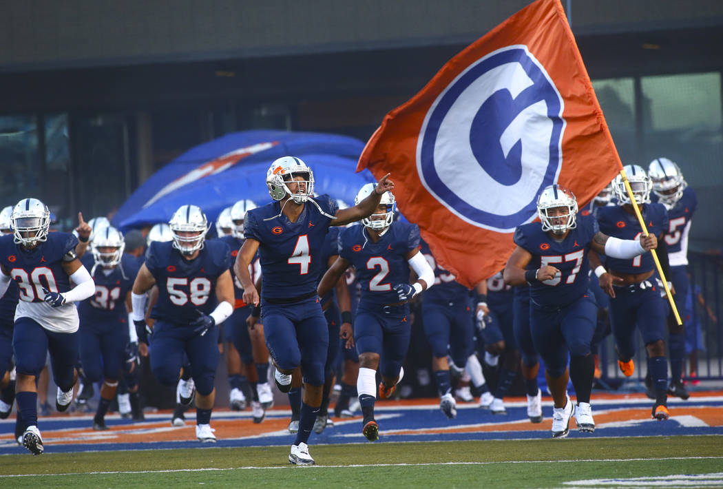 Bishop Gorman's Rome Odunze (4) points to the crowd as players enter the field before taking on ...