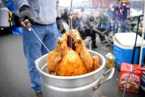 A tailgater deep fries a turkey at Eastern Market before an NFL football game between the Detro ...