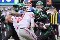 New York Jets strong safety Jamal Adams, right, strips the ball from New York Giants quarterbac ...