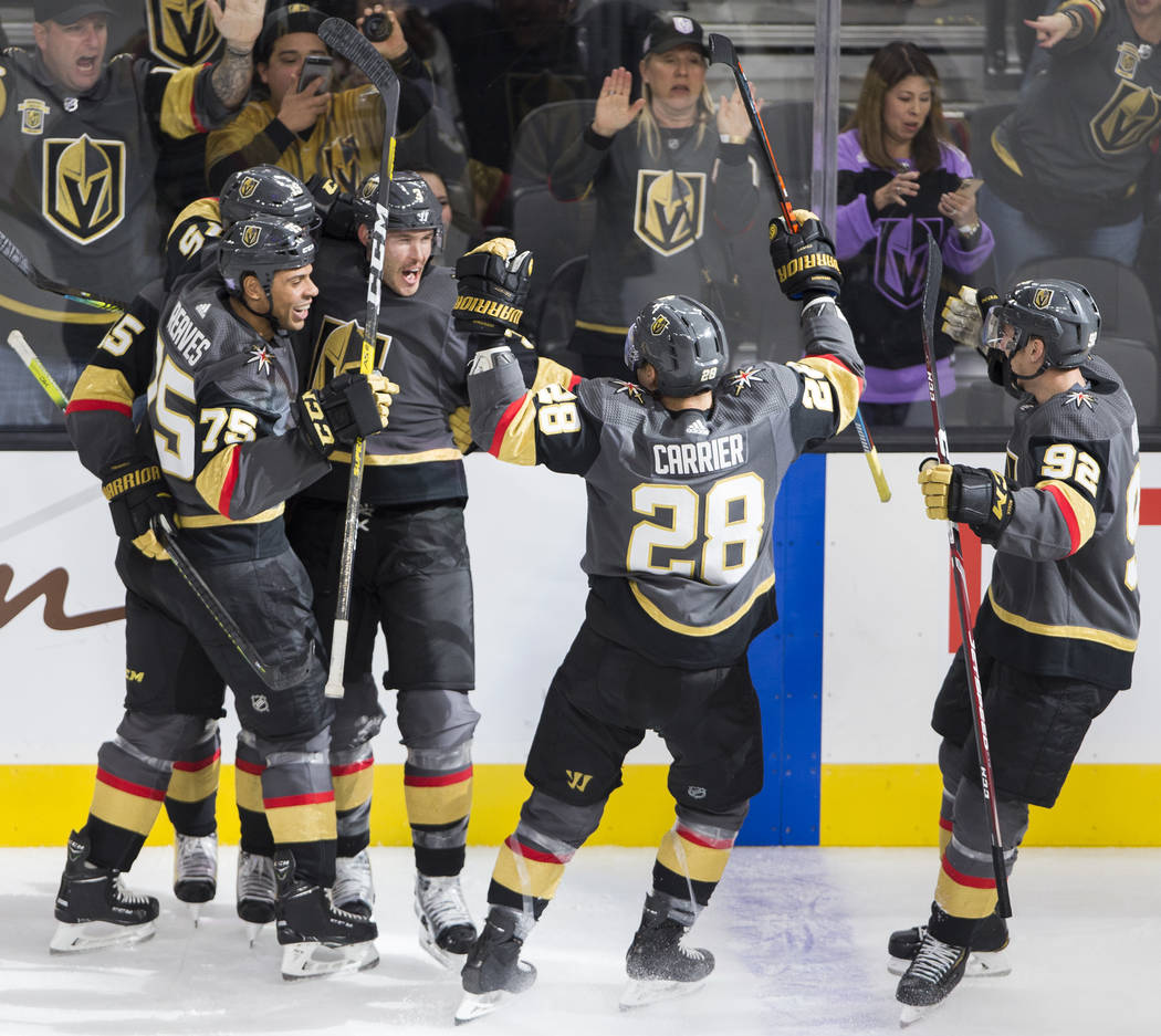Vegas Golden Knights right wing Ryan Reaves (75) celebrates with Vegas Golden Knights defensema ...