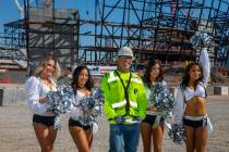 Labor concrete foreman Dave Durbin is flanked by the Raiderettes as he helps the Raiders announ ...