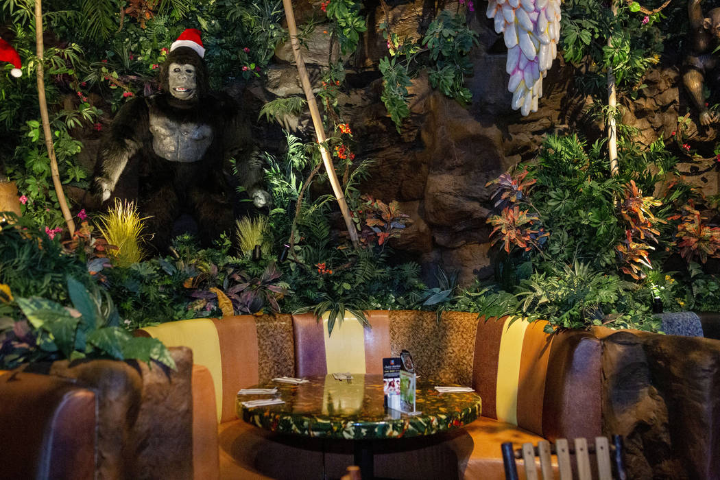 Dining tables covered by plants and mechanical animals in the Rainforest Cafe in the Miracle Mi ...