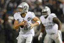 Oakland Raiders quarterback Derek Carr (4) rolls out to pass against the Los Angeles Chargers d ...