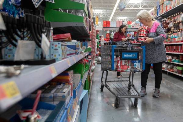JoAnn Torre, right, of Las Vegas shops for holiday-themed tins to fill with cookies for friends ...