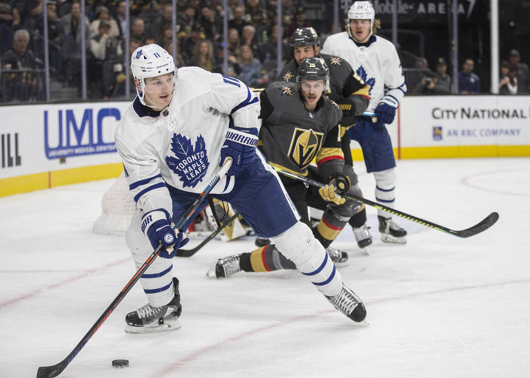 Toronto Maple Leafs center Zach Hyman (11) skates around Vegas Golden Knights defenseman Jon Me ...