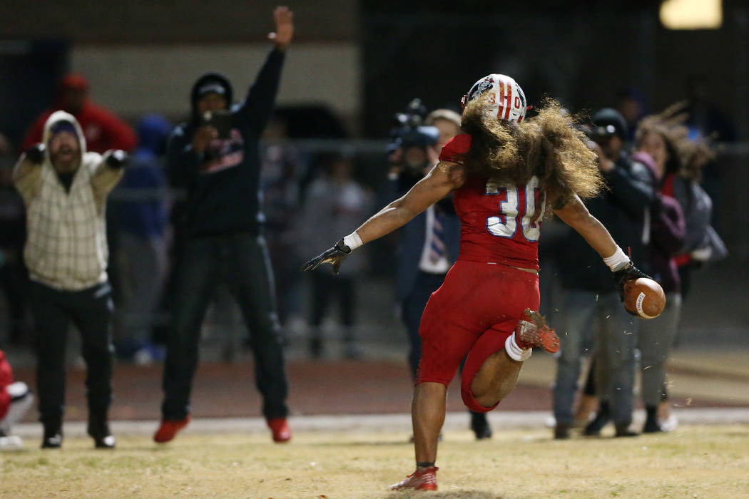 Liberty's Zyrus Fiaseu (30) scores a rushing touchdown to win in overtime against Bishop Gorman ...
