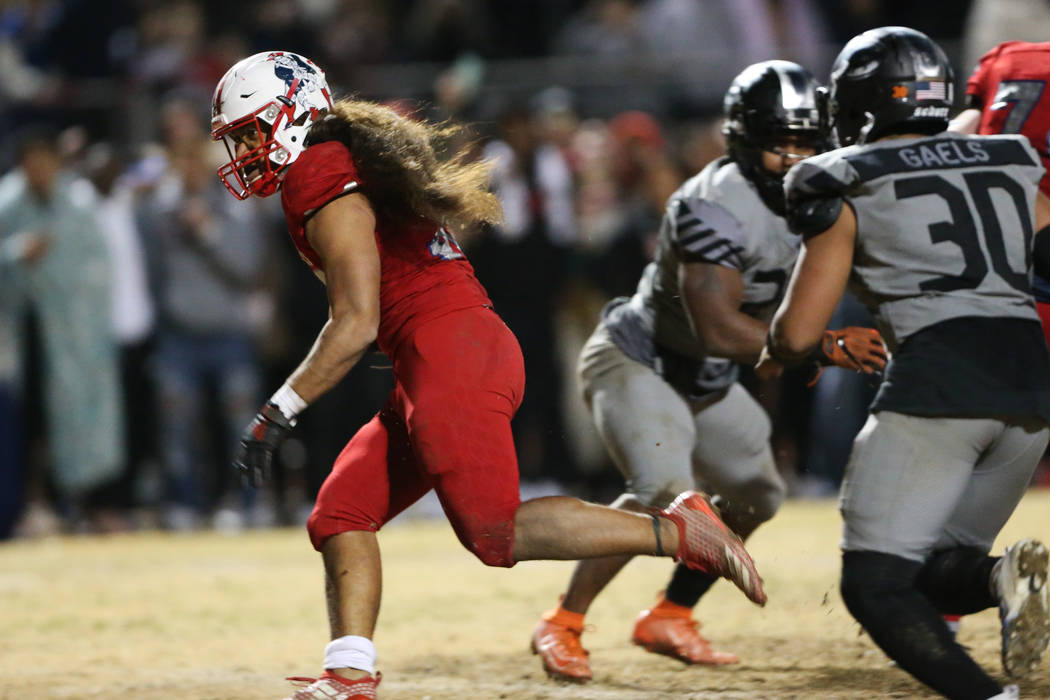 Liberty's Zyrus Fiaseu (30) rushes the ball for a touchdown to win in overtime as Bishop Gorman ...
