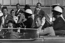 In this Nov. 22, 1963 file photo, President John F. Kennedy rides in a motorcade with his wife ...