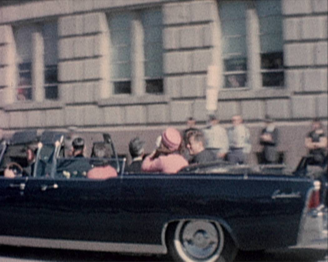 President John F. Kennedy and his wife, Jacqueline are shown riding in a motorcade moments befo ...