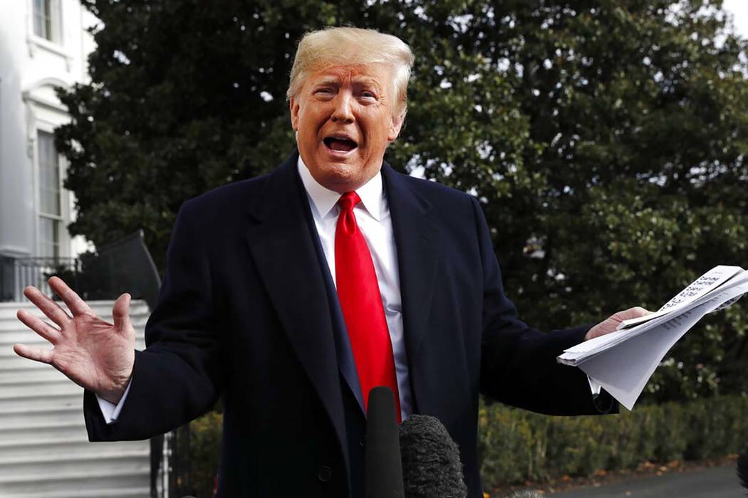 President Donald Trump holds handwritten notes as he speaks to the media about the House Intell ...