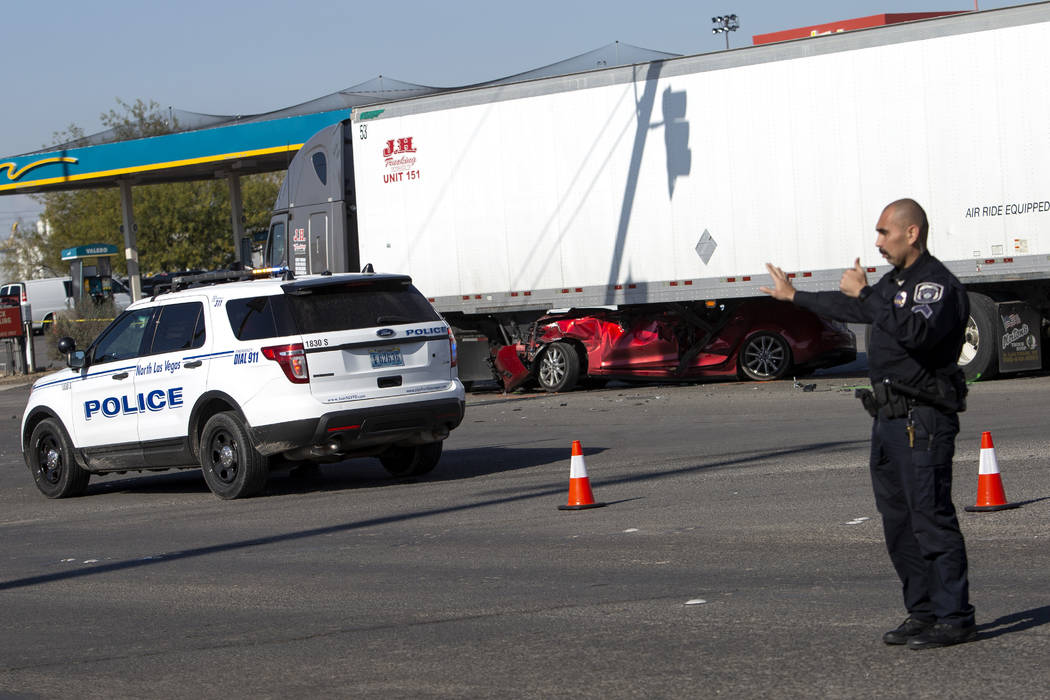 A North Las Vegas police officer commands traffic past a fatal crash that occurred at East Chey ...