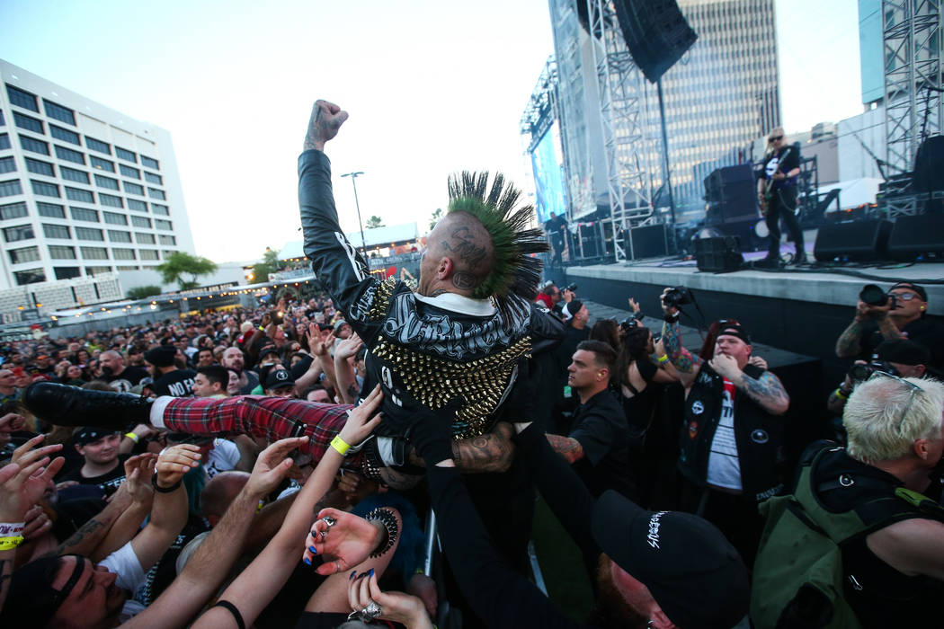 An attendee crowd surfs as L7 performs during the first day of the Punk Rock Bowling music fest ...