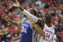 UNLV Rebels forward Cheikh Mbacke Diong (34) fights for a rebound with Kansas State Wildcats fo ...