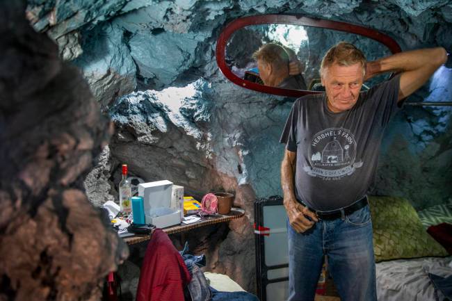 Richard Roman inside his bedroom area about living in a former mine in the hillside above the R ...