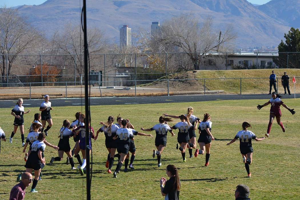 The Faith Lutheran girls soccer team celebrates the school's first-ever Class 4A state champion ...