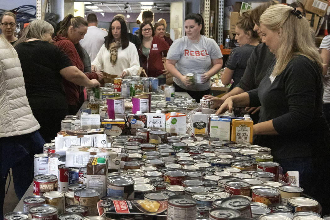 Attendees of The "Done in a Day" event fill approximately 2,500 bags of donated food ...