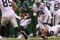 New York Jets wide receiver Braxton Berrios (10) breaks a tackle from Oakland Raiders running b ...