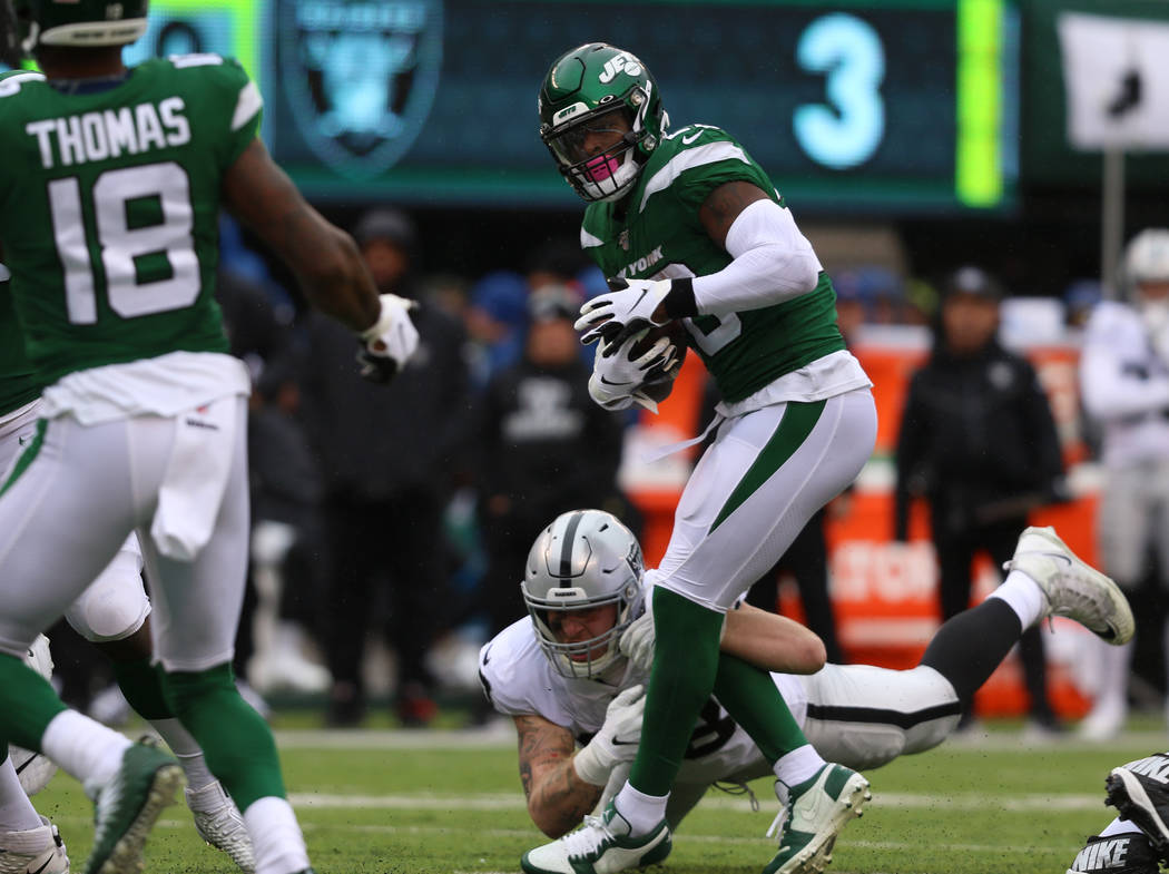 Oakland Raiders defensive end Maxx Crosby (98) can't tackle New York Jets running back Le'Veon ...