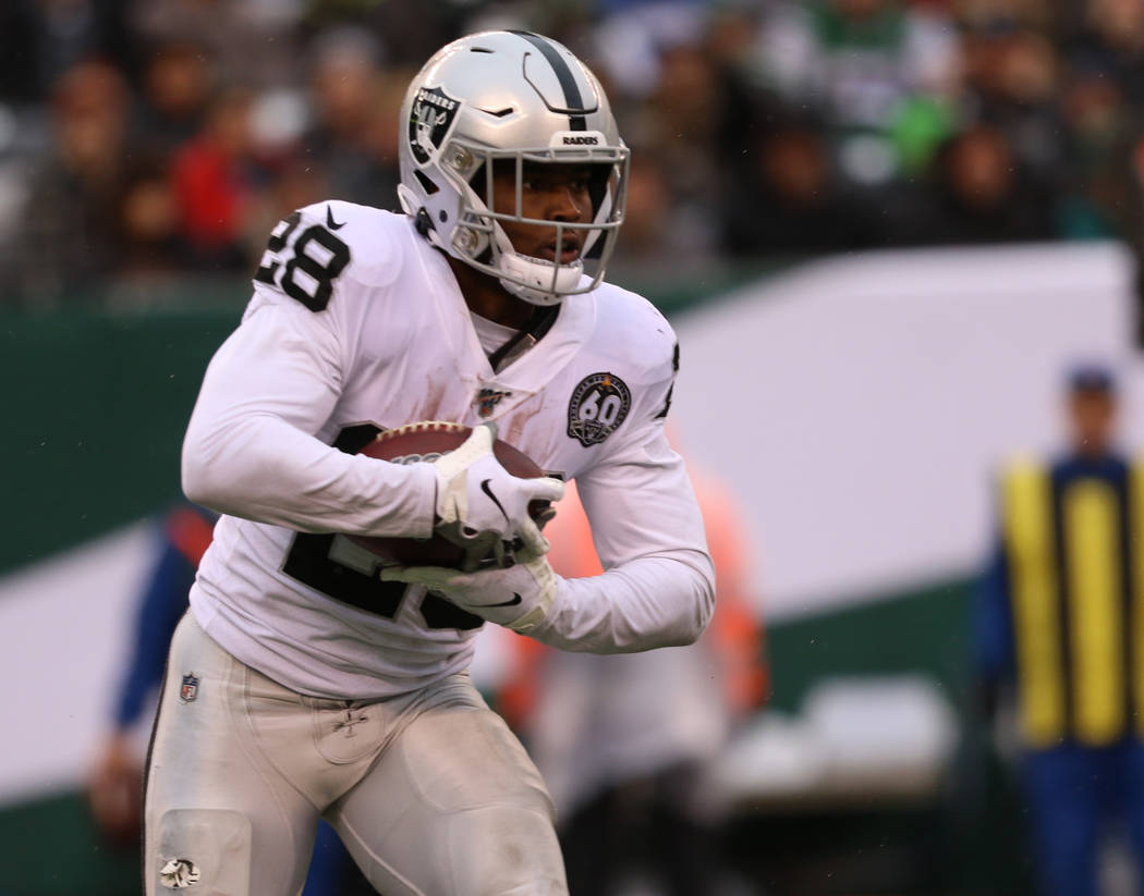 Oakland Raiders running back Josh Jacobs (28) runs with the football during the first half of a ...