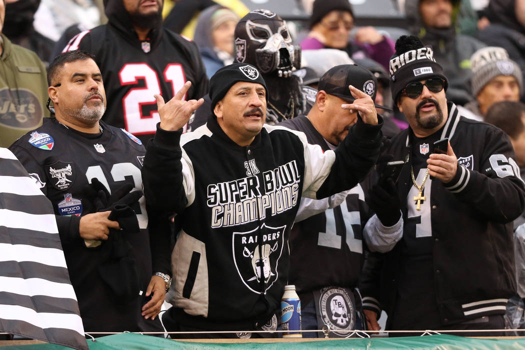 Oakland Raiders fans react as they watch the second half of an NFL game against the New York Je ...