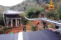 Firefighters work in the area where a stretch of the Turin to Savona A6 highway collapsed follo ...