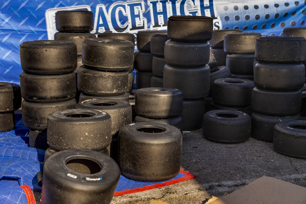 Spent kart tires are stacked up beside a garage in the pits during the SKUSA SuperNationals at ...
