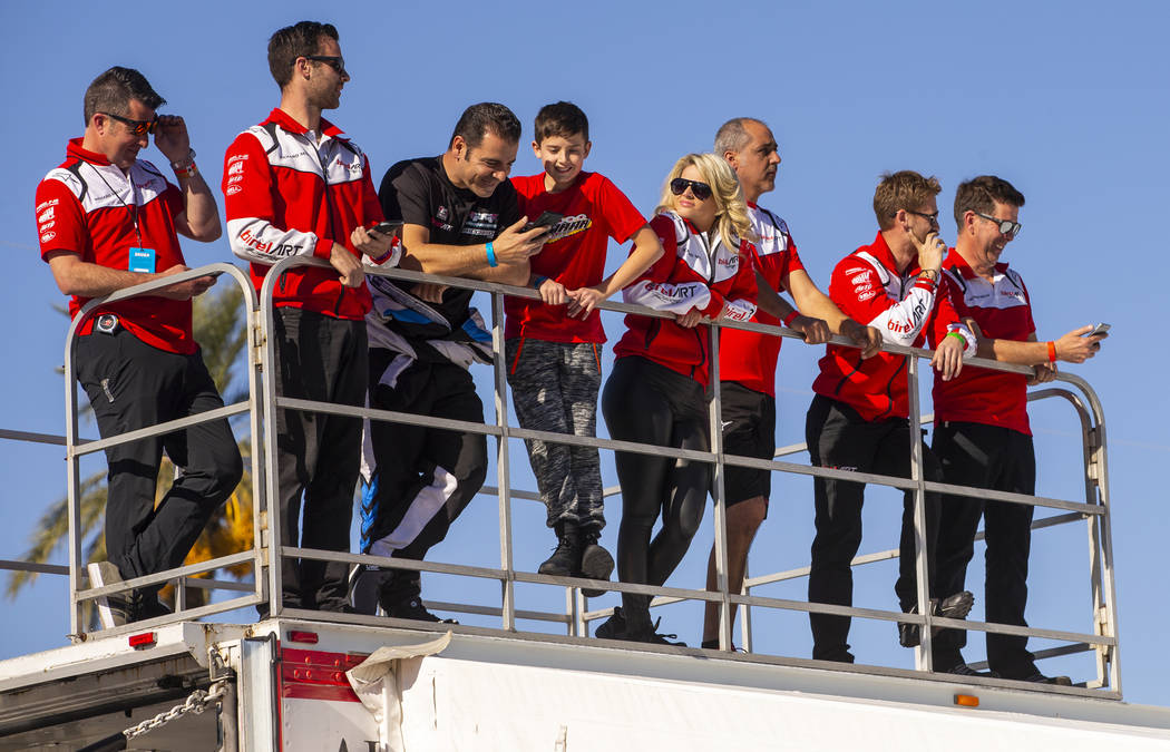 Members of the Italian Birel ART chasis for karts enjoy the races from atop of their garage dur ...