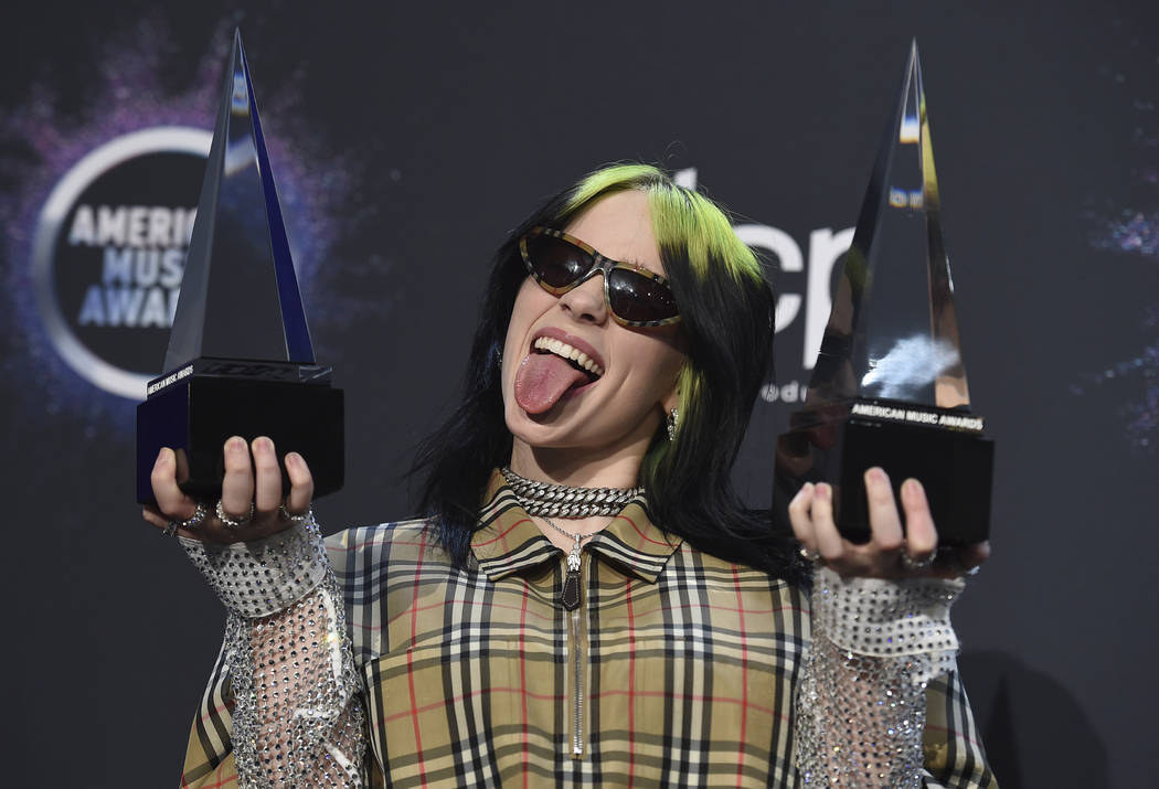 Billie Eilish poses in the press room with the award for new artist of the year and favorite al ...