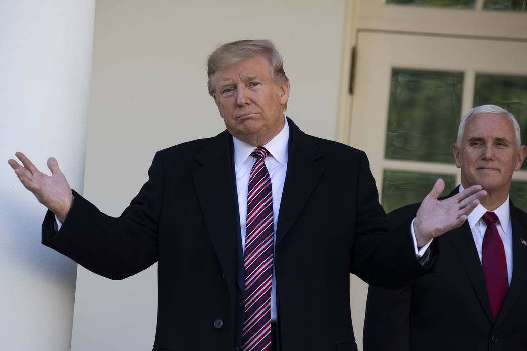 Vice President Mike Pence listens as President Donald Trump talks with reporters during a visit ...