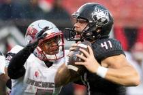 Arkansas State punter Cody Grace (41) handles the ball as UNLV defensive back Jericho Flowers ( ...