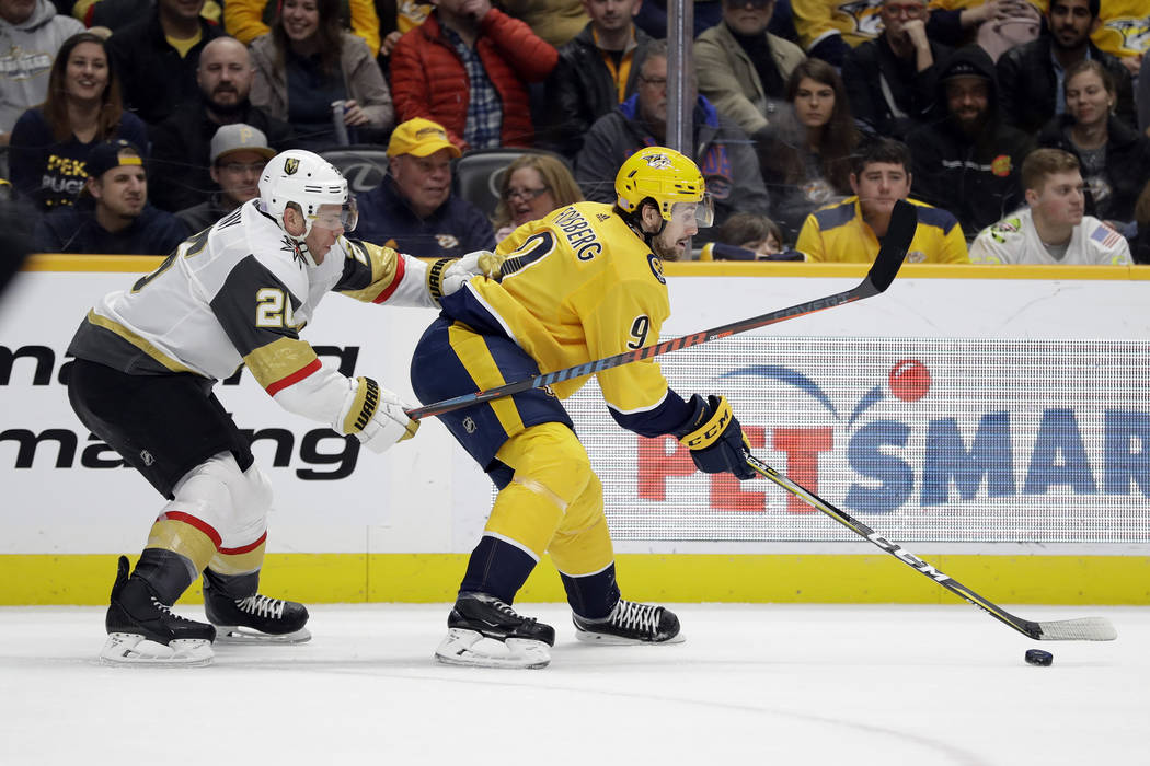 Nashville Predators left wing Filip Forsberg (9), of Sweden, is defended by Vegas Golden Knight ...