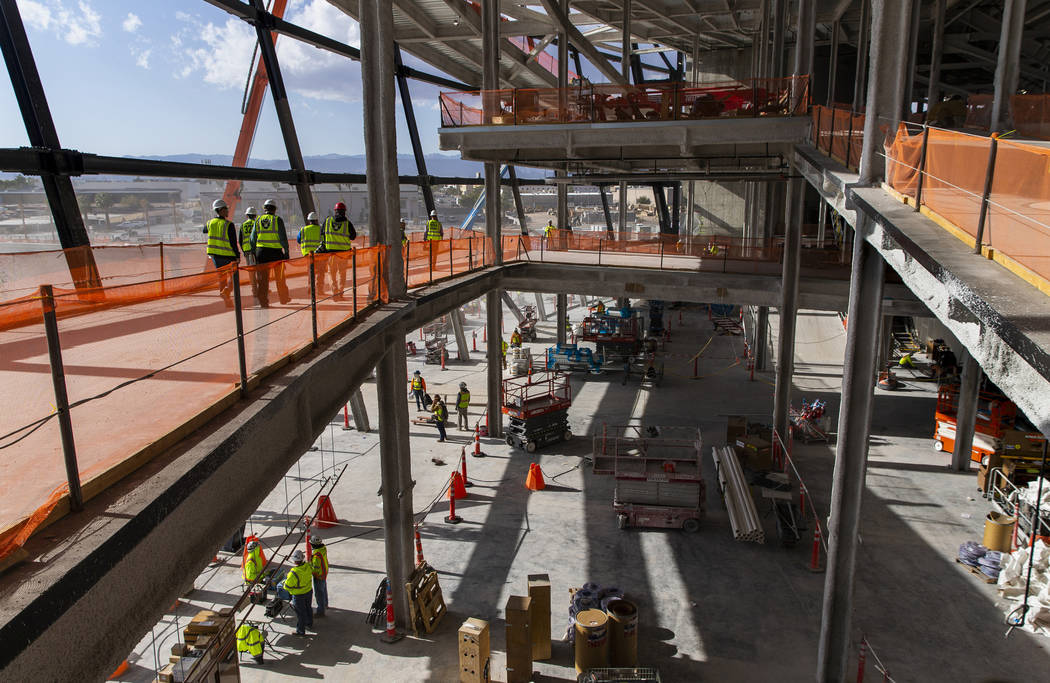 Crews continue work about the concourse area during a tour of the Raiders Allegiant Stadium con ...